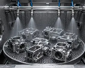 Multiple nozzles spraying metal components