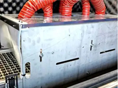 Machine head and red hoses inside equipment