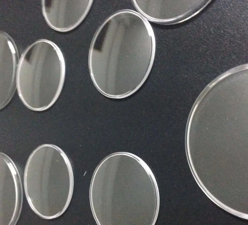 Circular glass samples on a dark background