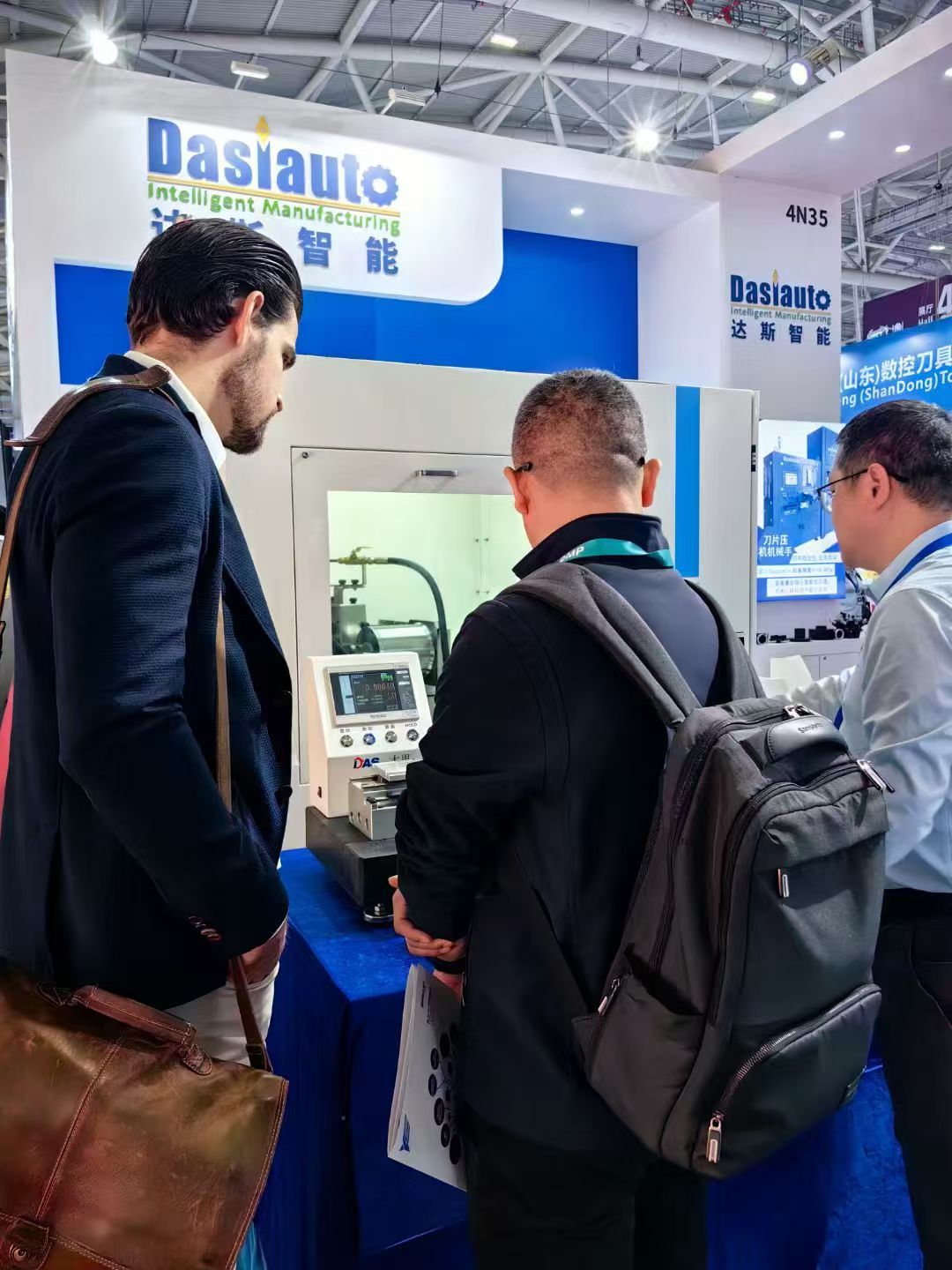 People standing beside an exhibition display