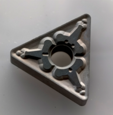 Triangular cutting insert pictured in the original article