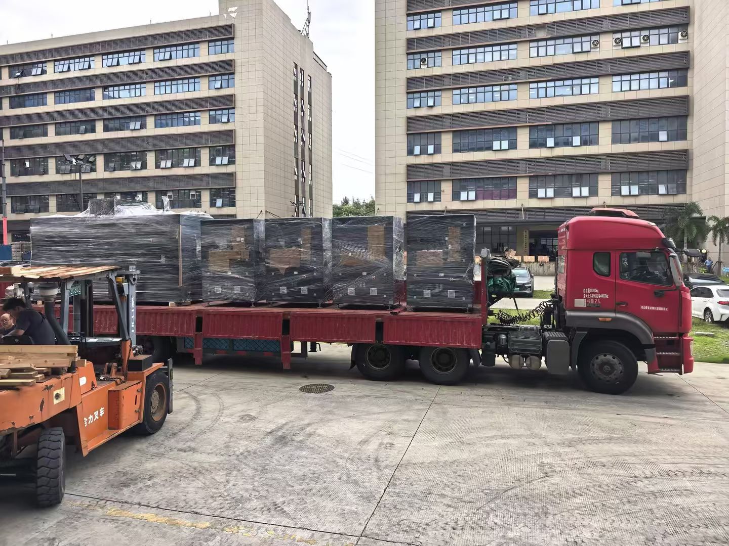 Wrapped equipment on a truck with a forklift alongside
