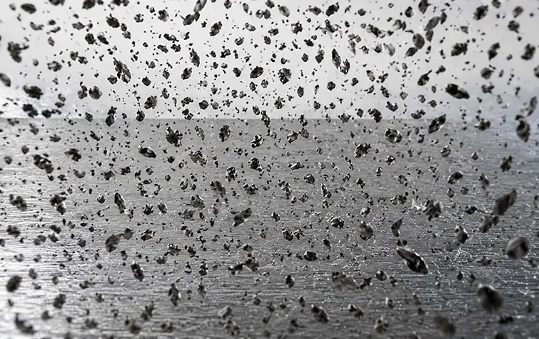 Particles shown above a textured surface in the original process illustration