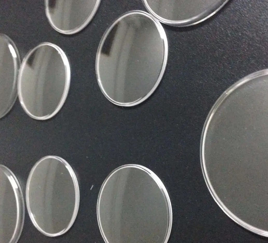 Circular glass samples on a dark background