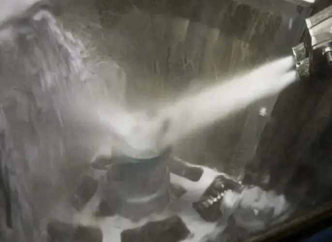 Spray directed toward a component inside a treatment enclosure